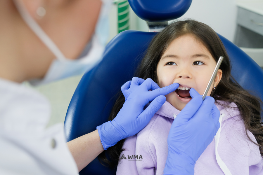 FAQs photo. Dentist and child during a consultation